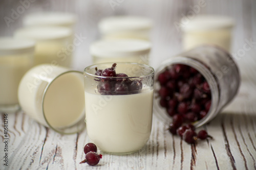 Homemade sweet yogurt with frozen berries in a glass