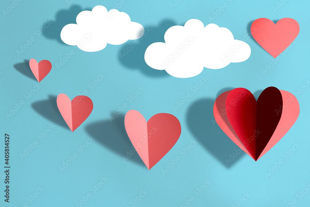 Valentines day concept,Paper cutting technique ,Paper hearts and Paper Clouds on blue background.