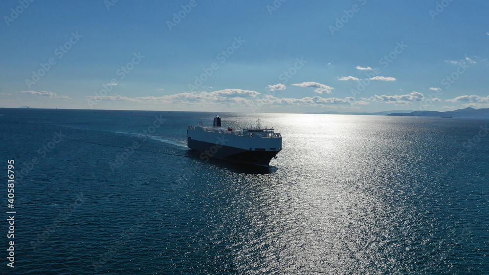 Aerial drone photo of Large RoRo (Roll on-off) car transportation vessel cruising the Mediterranean deep blue sea