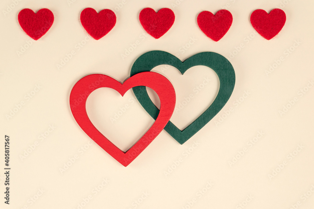 Hearts on pastel peach colors. Red and green hearts. Valentine's Day background. Valentine's Day concept. Flat lay.