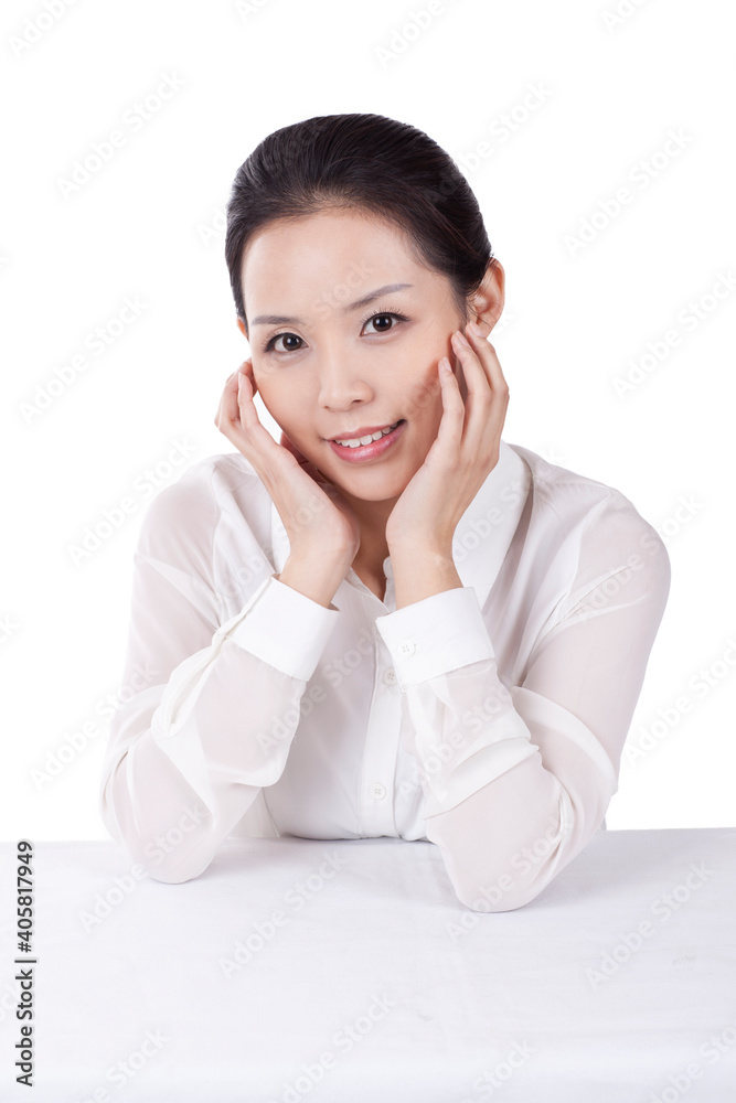 Portrait of young female office worker with hands on chin Portrait of young female office worker with hands on chin