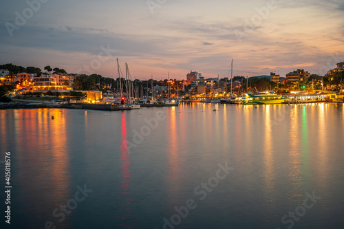 A long exposure image of the Porto Cristo port at evening twilight on Mallorca island in Spain