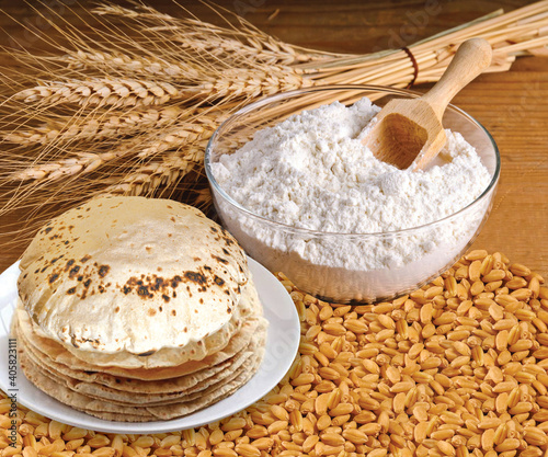 Rustic shot of a plate of chapati surrounded by ingredients photo