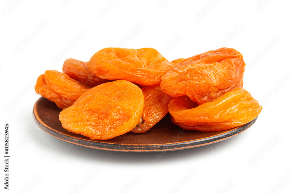 Dried apricots fruit in a plate, isolated on white background, close up view Dried apricots fruit in a plate, isolated on white background, close up view