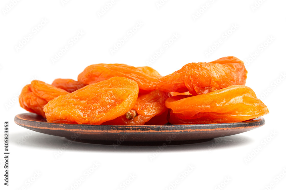 Dried apricots fruit in a plate, isolated on white background, close up view Dried apricots fruit in a plate, isolated on white background, close up view