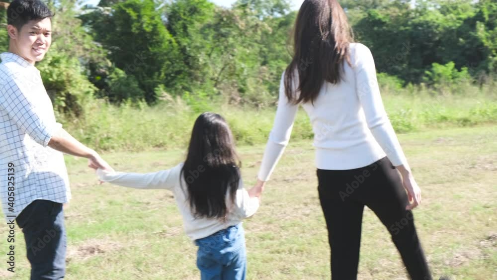 Asian Family trip father mother and daughter enjoy walking freedom in garden to nature.lifestyle family vacation caucasian asian.one day trip new normol during Coronavirus covid-19