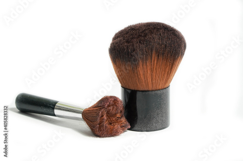 Professional makeup brushes through hard use on light backgrounds.Copy space for your text. Make-up brushe over white background. Aerial view of various brushes. Various makeup brush sizes. 