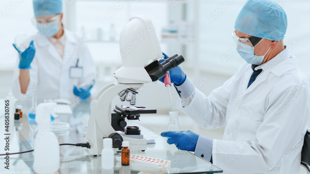 close up. scientists studying the influenza strains . close up. scientists studying the influenza strains .