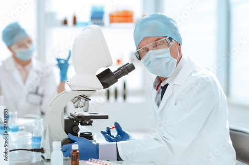 close up. ambitious scientist sitting at a laboratory table .