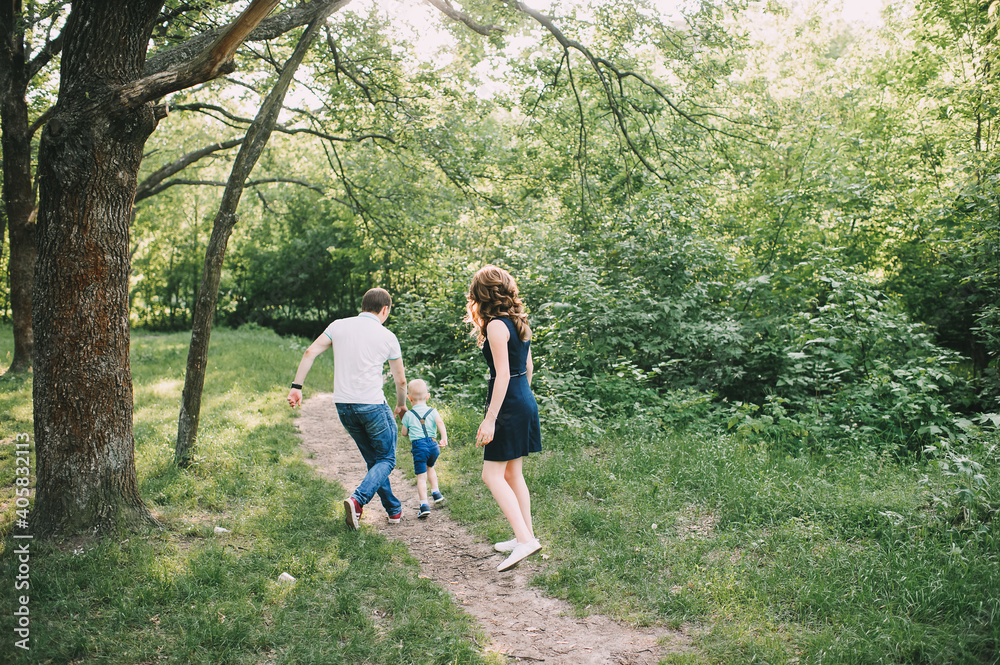 parents walk with their son in nature