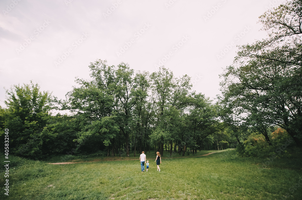 parents walk with their son in nature parents walk with their son in nature