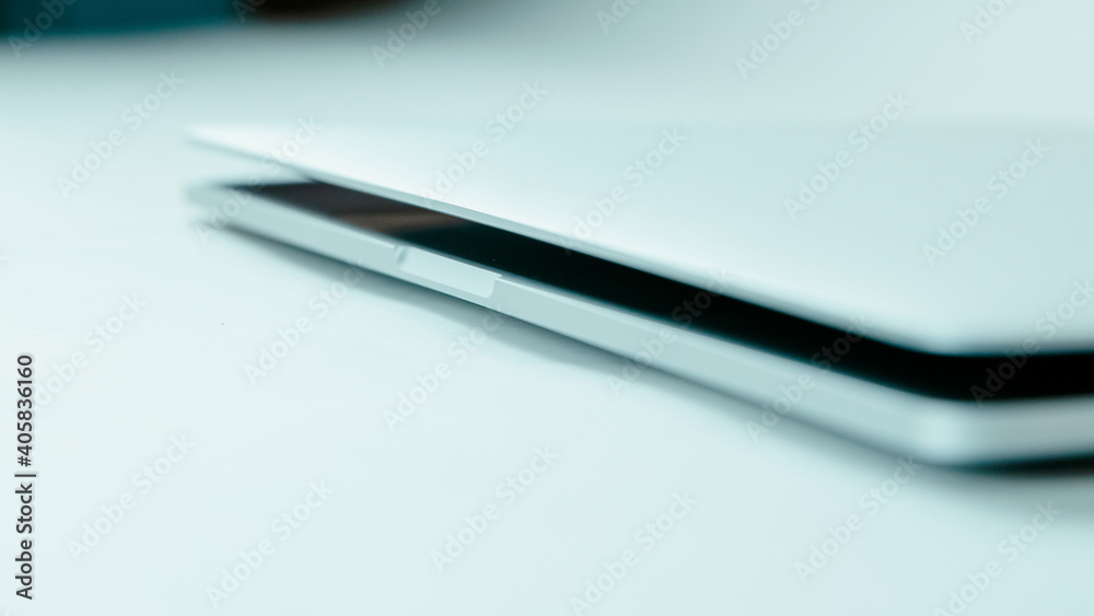 image of a slightly open laptop on a light background.