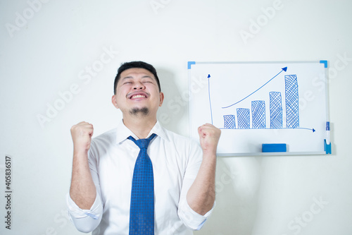 Young Asian businessman smiling happy Proud of the plan