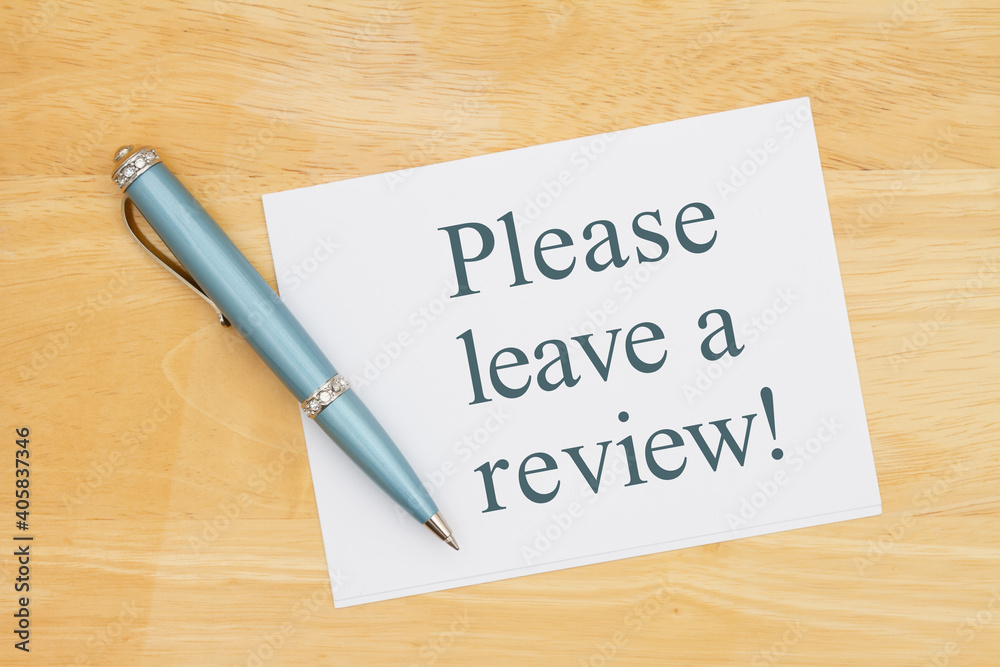 Please leave a review note with a pen on a desk Please leave a review note with a pen on a desk
