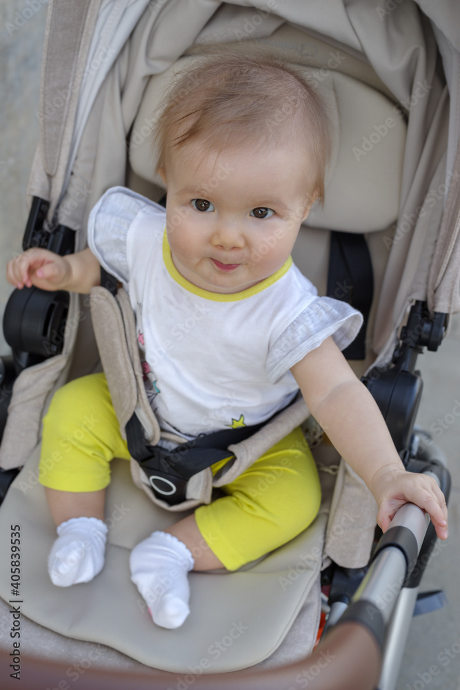 Baby girl sitting in stroller Baby girl sitting in stroller