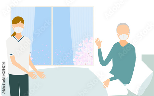 ベッドで体を起こす入院患者と看護師