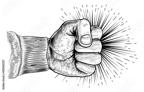 A hand in a clench fist punching in a vintage retro propaganda woodcut style