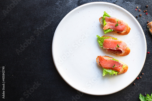 sandwich salmon fish bruschetta with seafood antipasto aperitif ready to eat on the table for healthy meal snack outdoor top view copy space for text food background image rustic diet pescetarian