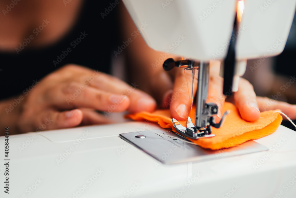 hand working with sewing machine