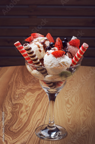chocolate and vanilla ice cream scoops with fresh fruit cookies and sauce