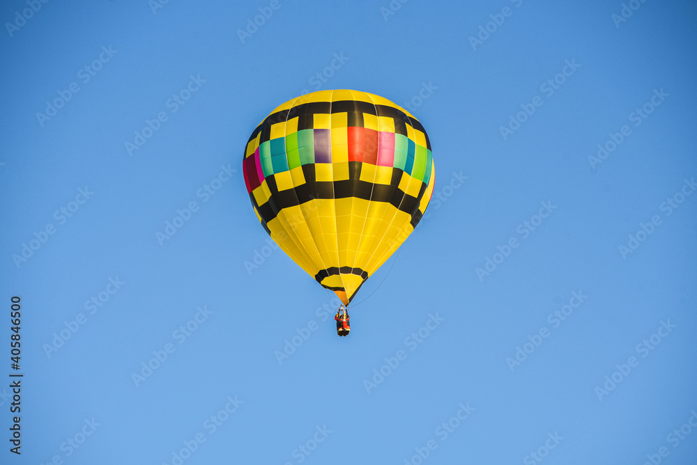 I captired this image one morning this past fall. You can see how the sky would change color as I took pictures from different angles, Hot air balloon floating free.