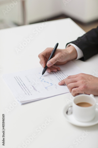 Portrait of young businessman writing in office