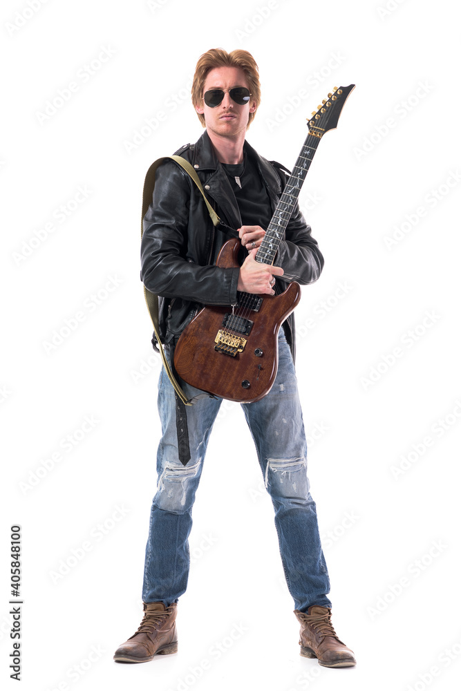 Macho stylish rocker with electric guitar and sunglasses wearing leather jacket and jeans. Full body isolated on white background. Macho stylish rocker with electric guitar and sunglasses wearing leather jacket and jeans. Full body isolated on white background.