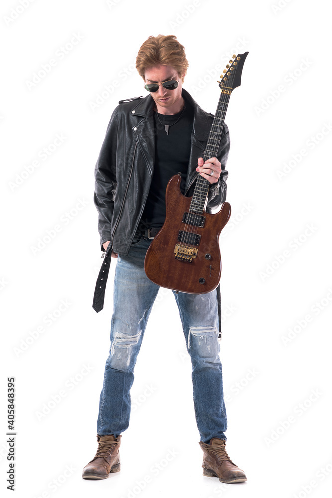 Stylish handsome male rock guitarist getting ready prepare for concert with electric guitar. Full body isolated on white background. Stylish handsome male rock guitarist getting ready prepare for concert with electric guitar. Full body isolated on white background.