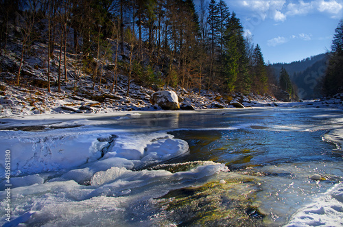 Mountain clear melt water in the river during the winter thaw or spring warming.