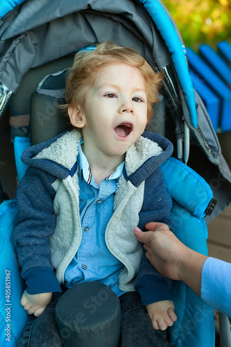 Disabled child on wheelchair is play and learn in the outdoor park like other people