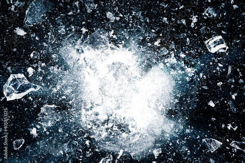 Ice, crushed on black background. Pieces of crushed ice spreading away. The explosion of ice.