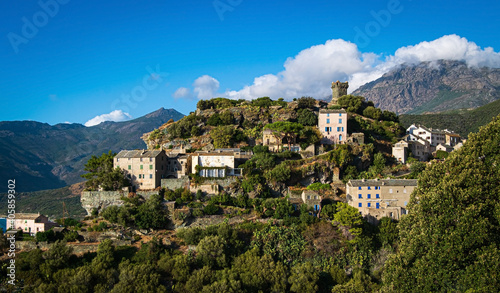 The village Nonza, located both the side of a cliff, Cap Corse, Corsica, France. Tower (Tour Paoline) on top of the cliff