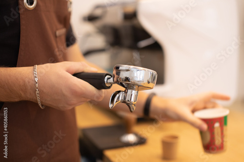 Close-up of espresso pouring from coffee machine. Professional coffee brewing. Focus selection point .