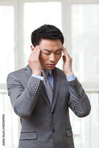 Portrait of young businessman got a headache