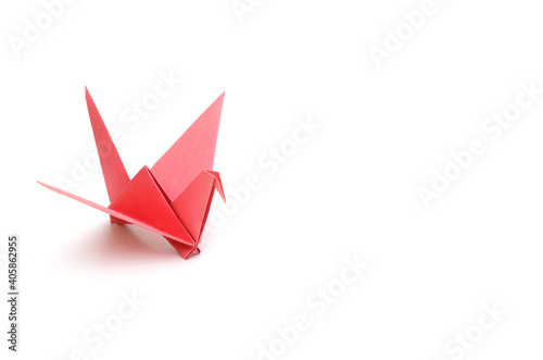 A red origami bird on white