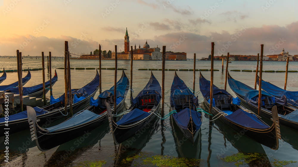 Gondolas moored in St. Mark's Square facing San Giorgio Maggiore church. Dawn in Venice, Italy