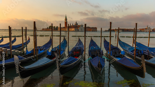 Gondolas moored in St. Mark's Square facing San Giorgio Maggiore church. Dawn in Venice, Italy © Paulista