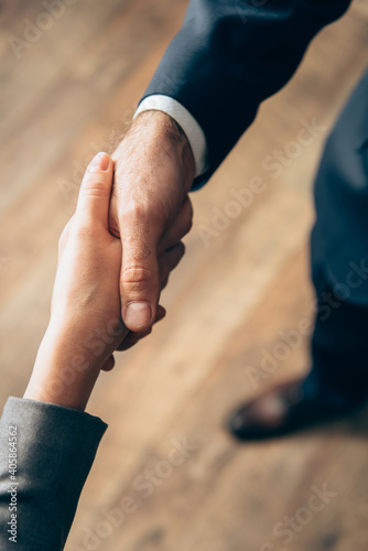 Cropped view of business people handshaking in office
