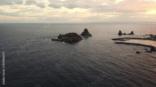 Drone view Lachea Island of Acitrezza bay at sunset in Sicily Italy