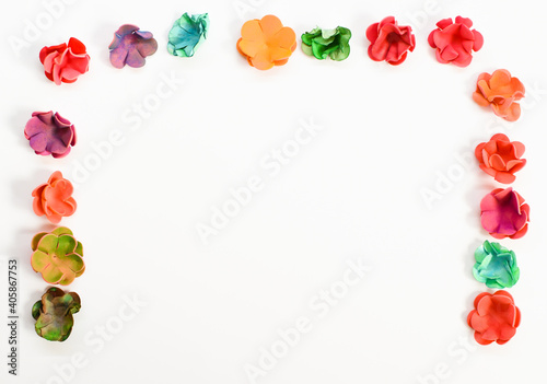 Frame made of colorful flowers on a white background. Multi-colored flowers. Bright composition. Top view  copy space