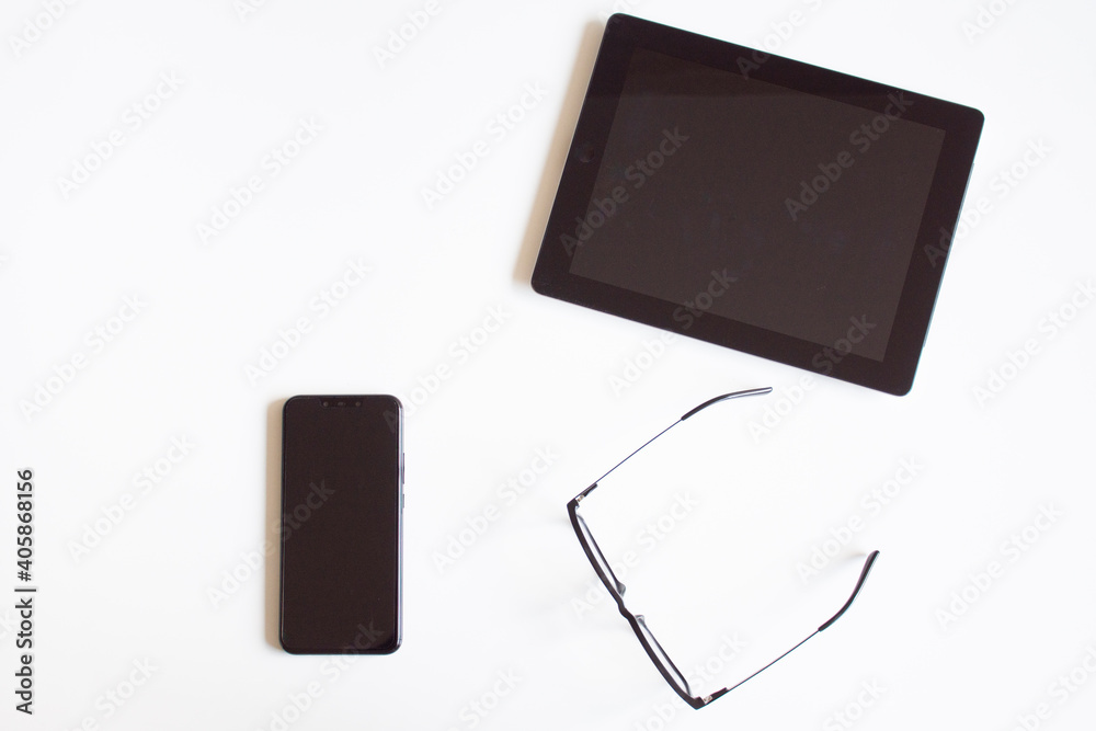 Necessary tools for office work, tablet, cell phone and glasses. Necessary tools for office work, tablet, cell phone and glasses.