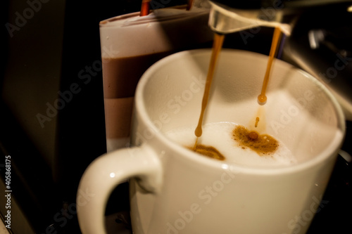 Close-up of how the coffee leaves the machine to be served in the cup  its foam and golden color of the coffee can be appreciated