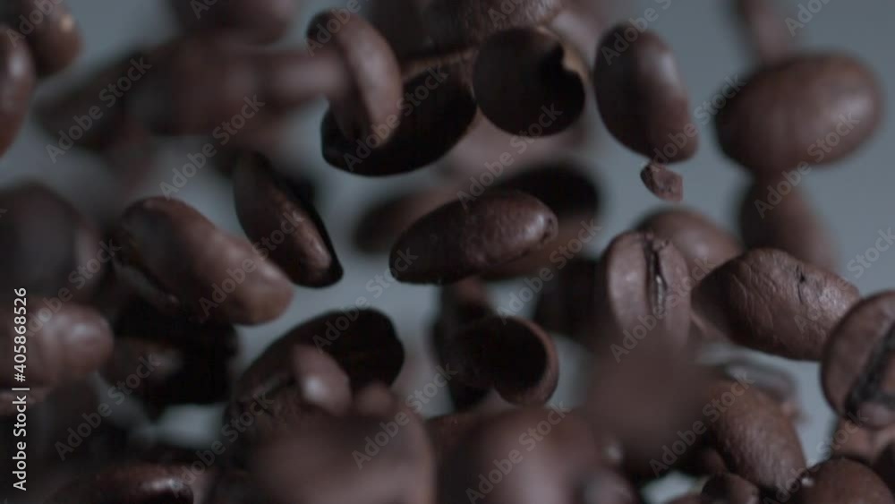 Coffee beans in slow motion suspended in the air bouncing and falling