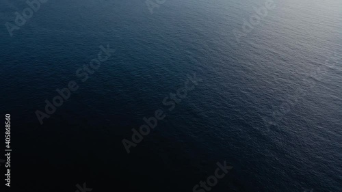 Flying over the blue surface of the sea or ocean photo