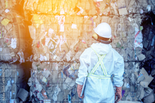 Waste processing plant. Technological process plastic bottles at the factory for processing and recycling. The worker recycling factory,engineers is out of focus or blurred.