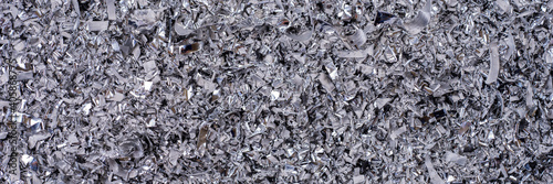 Metal shavings. Panoramic background of metallic chips. Processing of ferrous metals in a factory