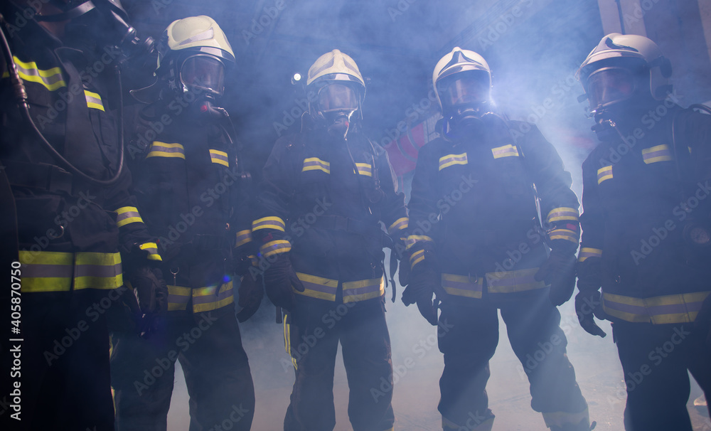 Portrait of group of firefighters in the middle of the smoke of the fire extinguisher Portrait of group of firefighters in the middle of the smoke of the fire extinguisher