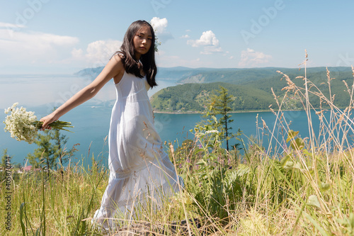 A girl of Buryat appearance on Lake Baikal photo