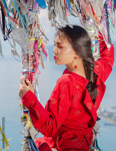 A girl of Buryat appearance on Lake Baikal photo