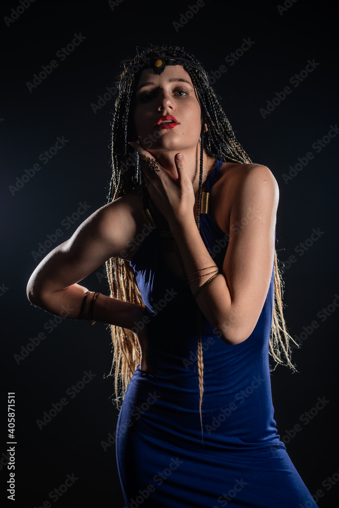 Fototapeta premium Portrait of a natural native, mystery girl wearing braids that looks like an ancient goddess.